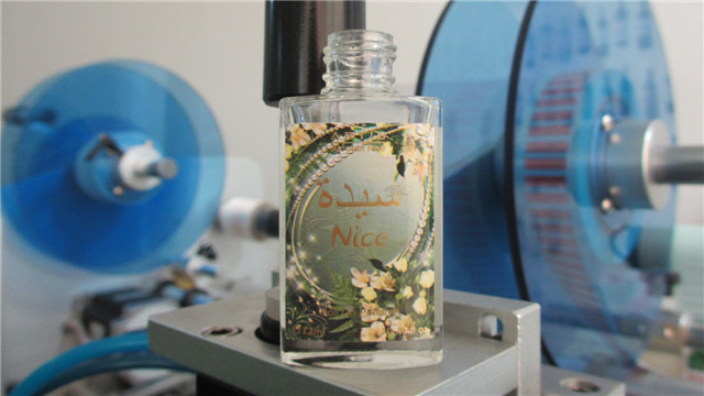 labeled bottle by  flat surface perfume bottle labeling mach