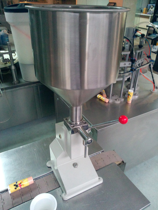 detailed view of the manual liquid filling machine hand oper