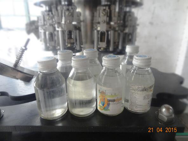 Bottles after capping by Automatic rotarty multi head ROPP c
